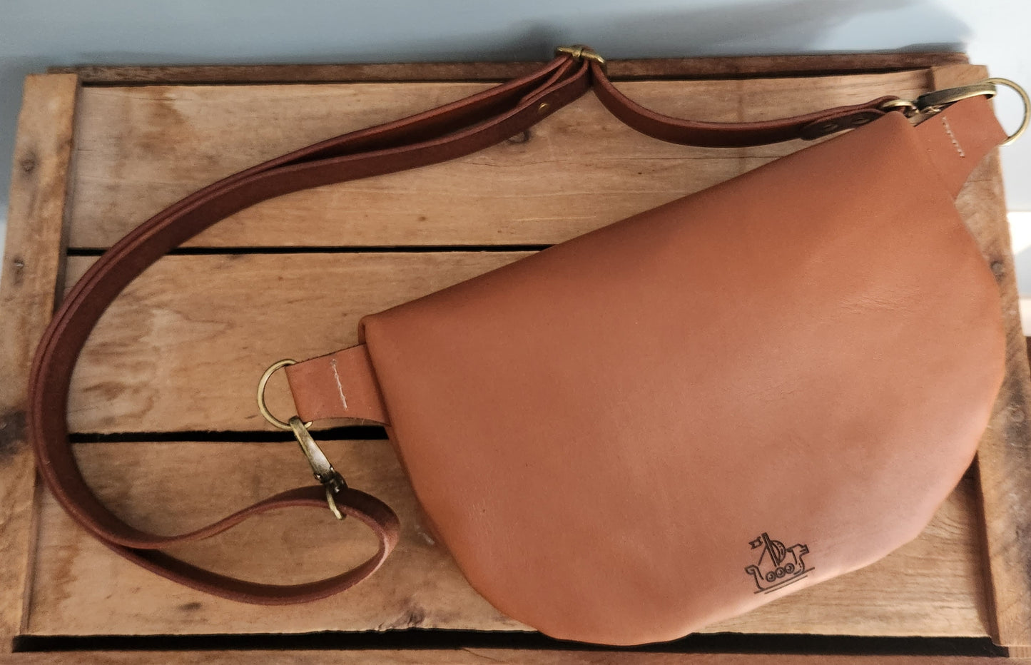 Rigid brown leather large sling bag